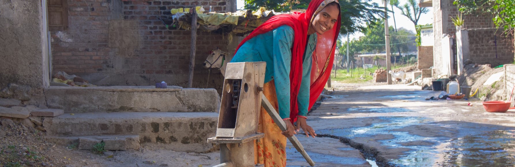 A woman in Jamgod village in Madhya Pradesh, India pumps water for her daily needs. Jamgod village is one of many where women are catalyzed to become water champions through the USAID Gap Inc. Women + Water Alliance.