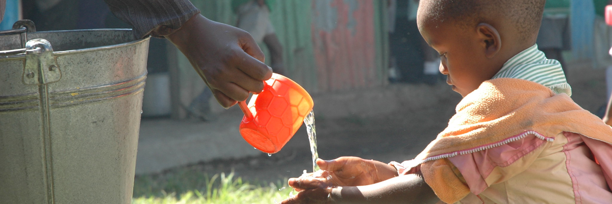 Handwashing in Kisumu, Kenya. Child washing hands with new water connection in Kisumu, Kenya. Photo credit: USAID/Kenya