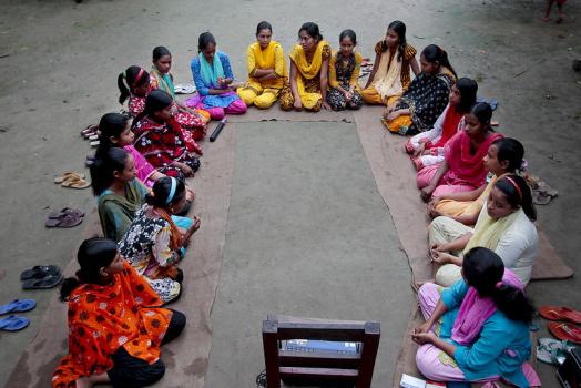 Salina Khatun, a 23-year-old Bangladeshi woman, last right, known as Tattahakallayani or Info Lady, sits with a group of Bangladeshi girls, aged between 12 and 17, hold courtyard meeting to teach about menstruation, reproductive health, HIV/AIDS and use of contraceptives at Saghata, a remote impoverished farming village in Gaibandha district, 120 miles (192 kilometers) north of capital Dhaka, Bangladesh. Dozens of Healthcare Providers known as “Info Ladies” bike into remote Bangladeshi villages with laptops