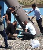 Staff of the Soran Water Directorate use ultrasonic flowmeters to measure the water flow through a main distribution pipe. Photo credit: WADA Tajdid Project