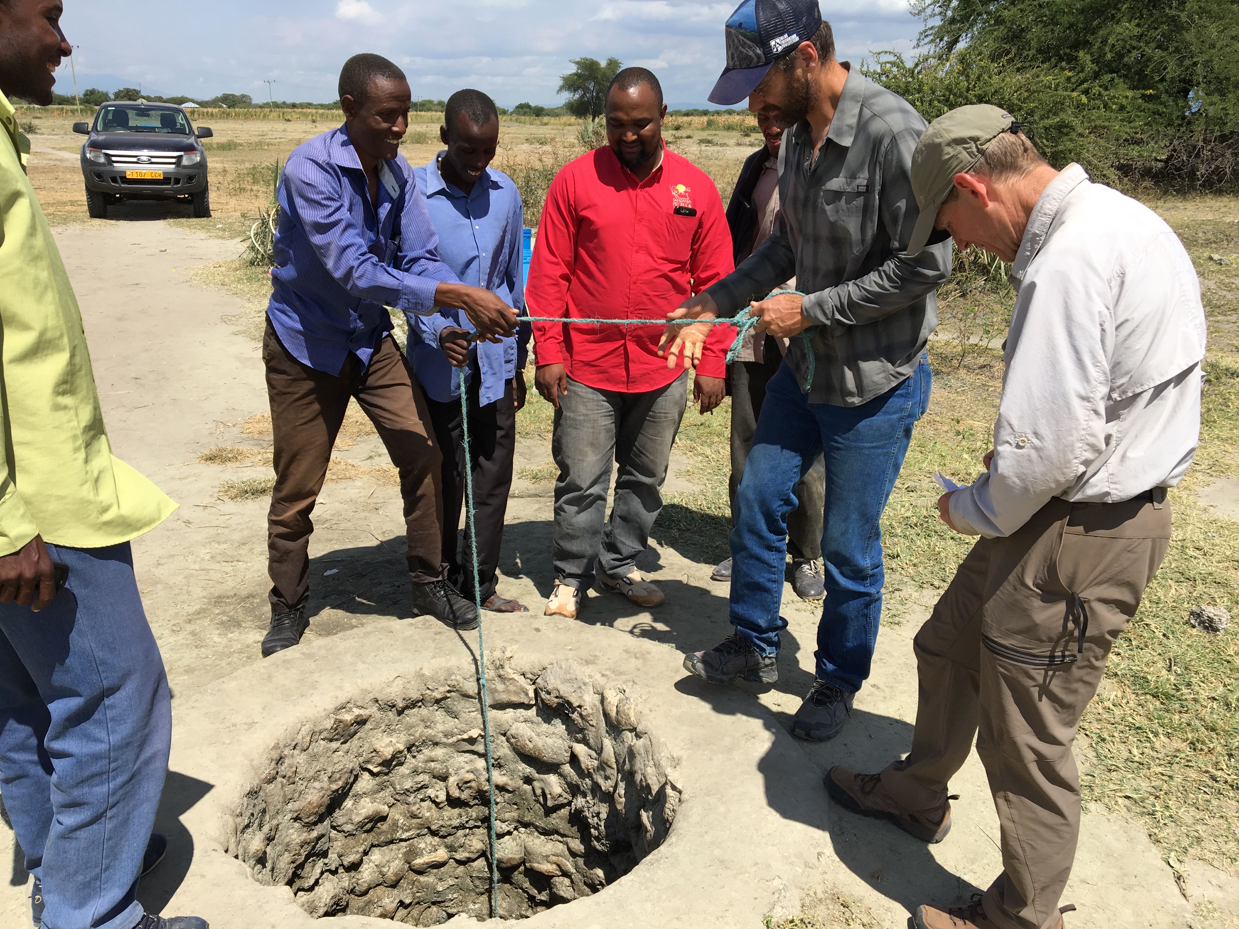 U.S. Forest Service technical specialists Dale Higgins (right) and Aric Johnson (second from right) investigate a well alongside community representatives in northern Tanzania as part of an effort to improve hydrological and rangeland management alongside the NGO Tanzania People & Wildlife. Credit: John Kerkering