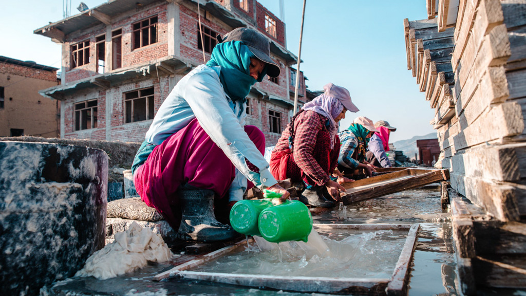 Women use water for making Lokta paper, a traditional Nepali paper. Many small industries in Nepal rely on water use. Photo: Pramin Manandhar