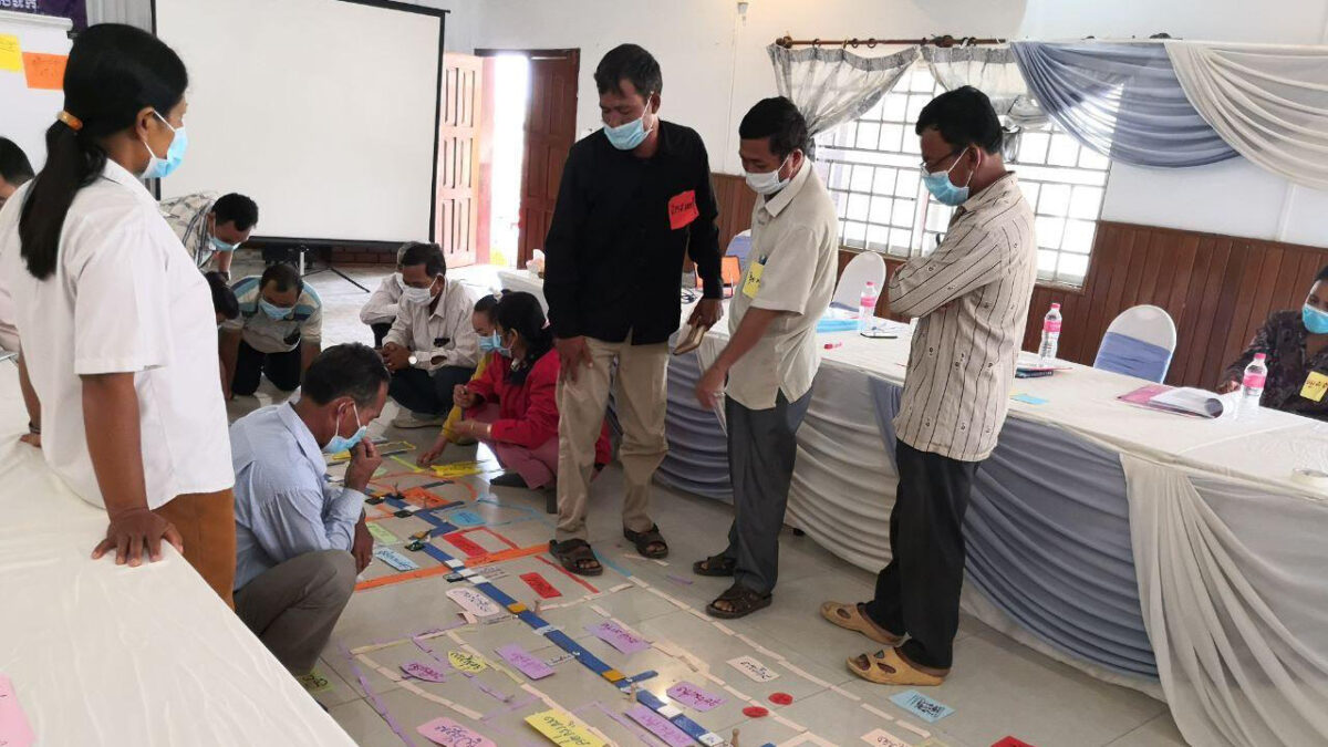 Farmers re-create their irrigation scheme using a game to enhance knowledge about irrigation in Cambodia. Photo By SWP.