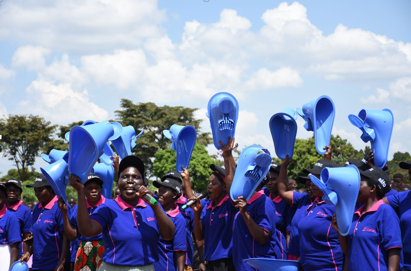 During World Toilet Day celebrations, the BRAC women hold sanitation products, such as SATO pans. Photo credit: Dorothy Nabatanzi