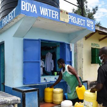 In Kenya, community members fetch water from a water kiosk owned and operated by Boya Water Project.     Photo credit: Chris Muturi/USAID KIWASH