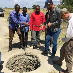 U.S. Forest Service technical specialists Dale Higgins (right) and Aric Johnson (second from right) investigate a well alongside community representatives in northern Tanzania as part of an effort to improve hydrological and rangeland management alongside the NGO Tanzania People & Wildlife. Credit: John Kerkering
