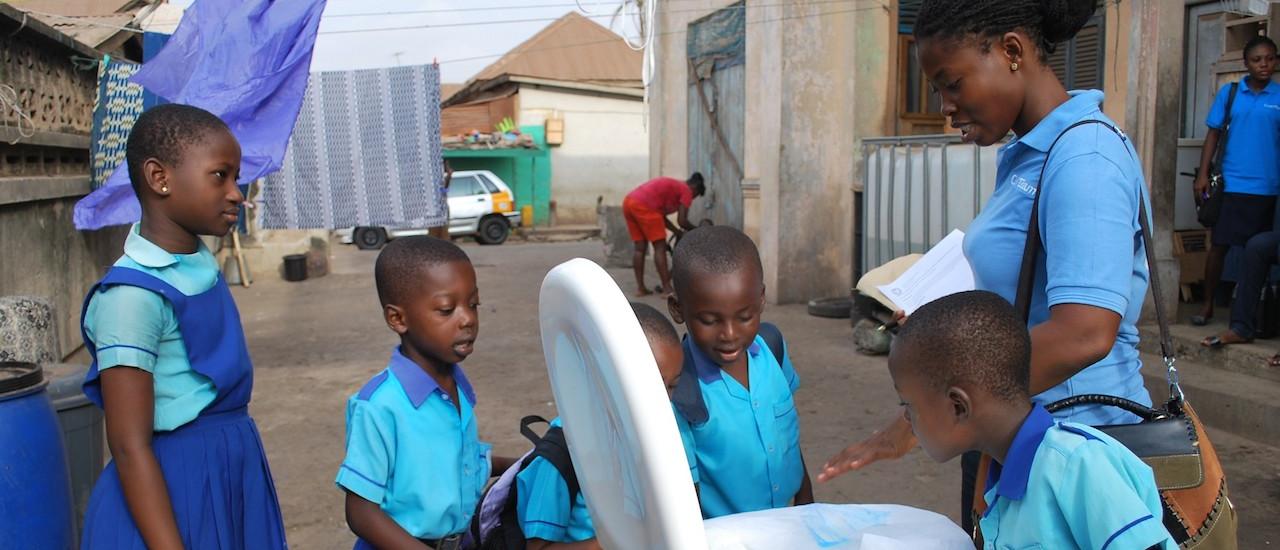 As part of USAID’s Sanitation and Service Delivery program, the Clean Team Ghana delivers new toilets and demonstrates how they work. Photo credit: Clean Team