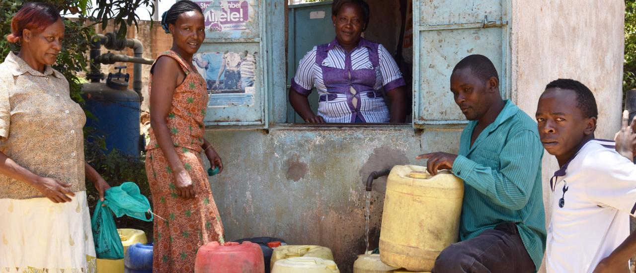 Christine Kanini, right, speaking with a customer in Makueni County, Kenya. Photo: USAID KIWASH