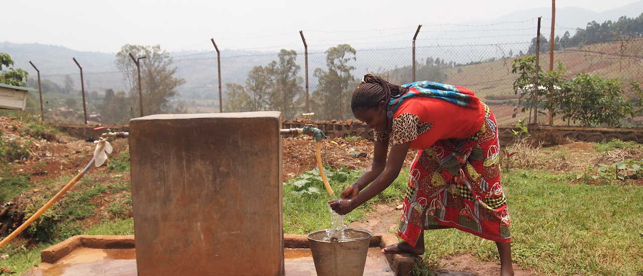 A woman washes her hands at an IHP-built water point at the Walungu General Referral Hospital. Photo credit: Rebecca Weaver