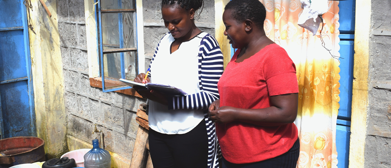 A water service provider marketer gets customer feedback from a residential caretaker. Photo credit: Rose Odengo, WASH-FIN