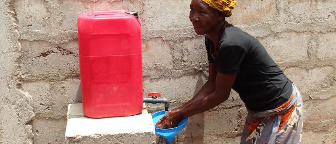 A women washes her hands with a Generation One handwashing station in Benin. Photo credit: Sanitation Service Delivery (SSD)