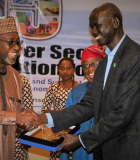 Host Minister for AMCOW's 15th Anniversary Celebration and Executive Committee meetings and Minister of Water Resources in Nigeria Suleiman Adamu presents Peter Mahal Akat, Direct General at the Ministry of Water Resources and Irrigation in South Sudan, with a gift of appreciation for his attendance. Photo credit: Emmanual C. Uguru/AMCOW